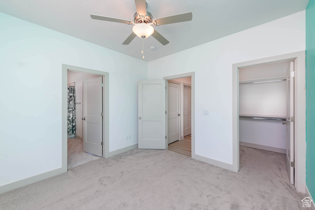 Unfurnished bedroom with light carpet, a closet, and ceiling fan