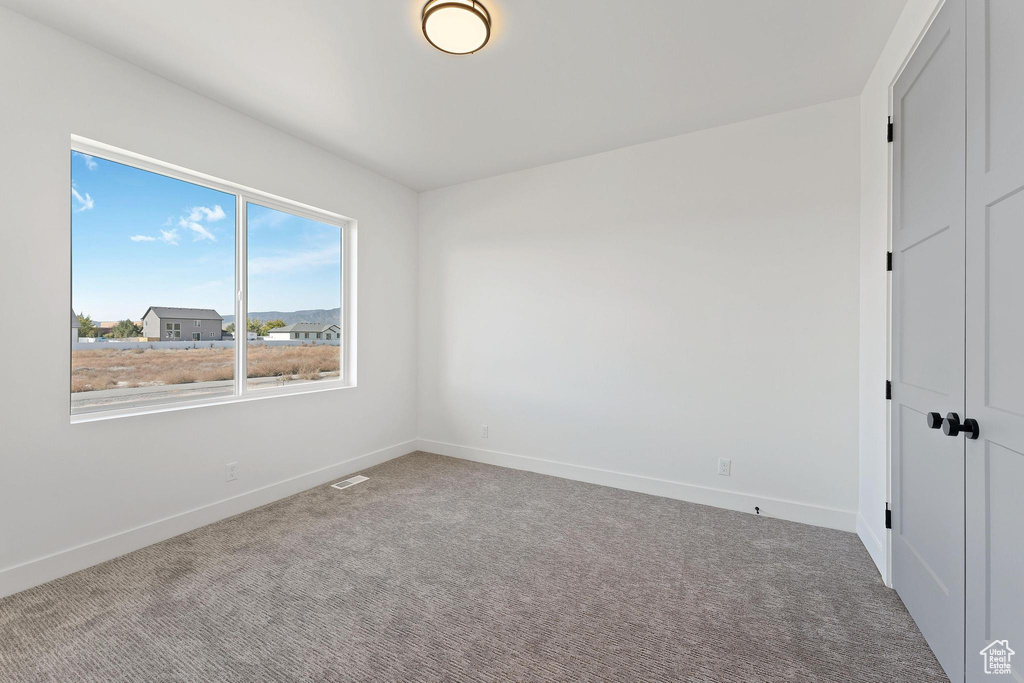 Empty room with carpet floors