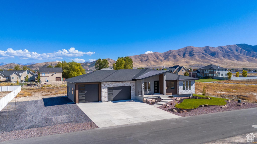 View of front facade featuring a mountain view and a garage