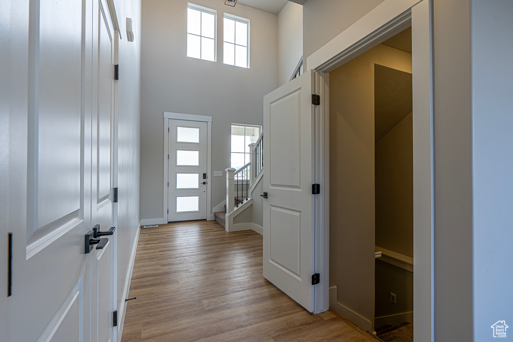 Foyer featuring light hardwood / wood-style flooring and a high ceiling