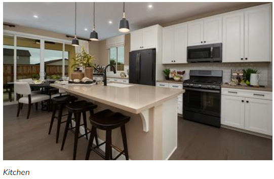 Kitchen with white cabinetry, black appliances, hanging light fixtures, and an island with sink