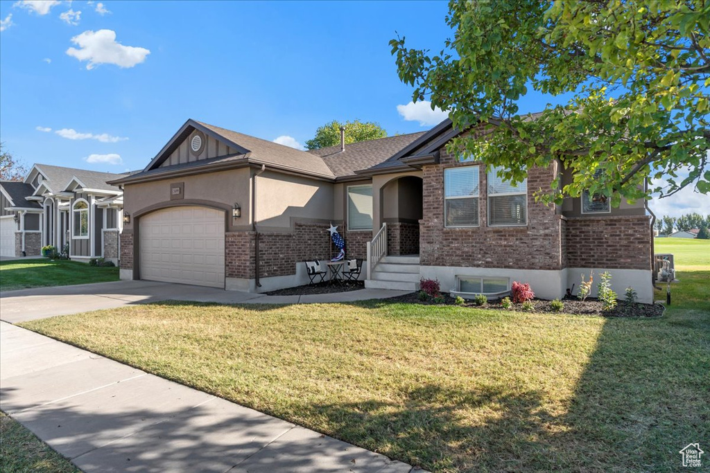 View of front of house with a front lawn and a garage