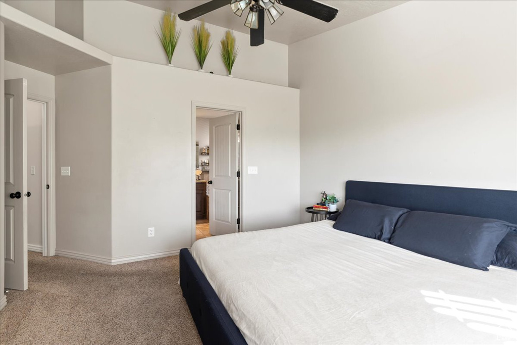 Carpeted bedroom with ceiling fan