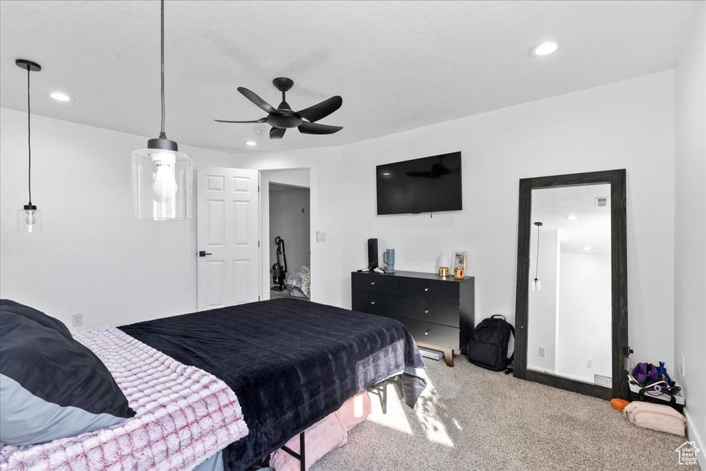 Carpeted bedroom with ceiling fan