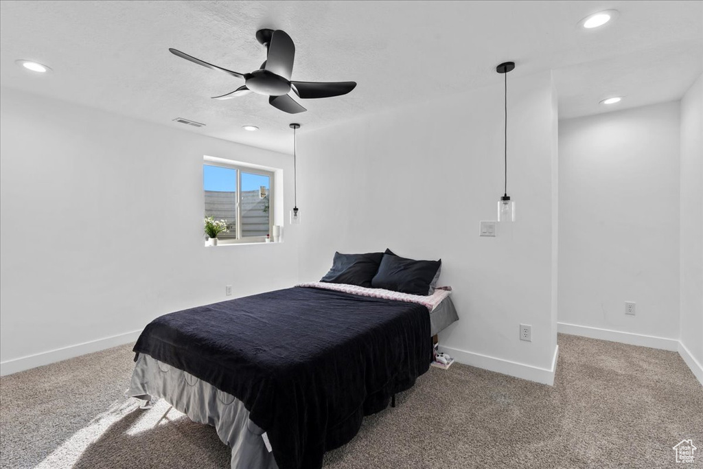 Carpeted bedroom with ceiling fan