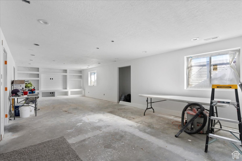 Interior space with a textured ceiling and built in shelves