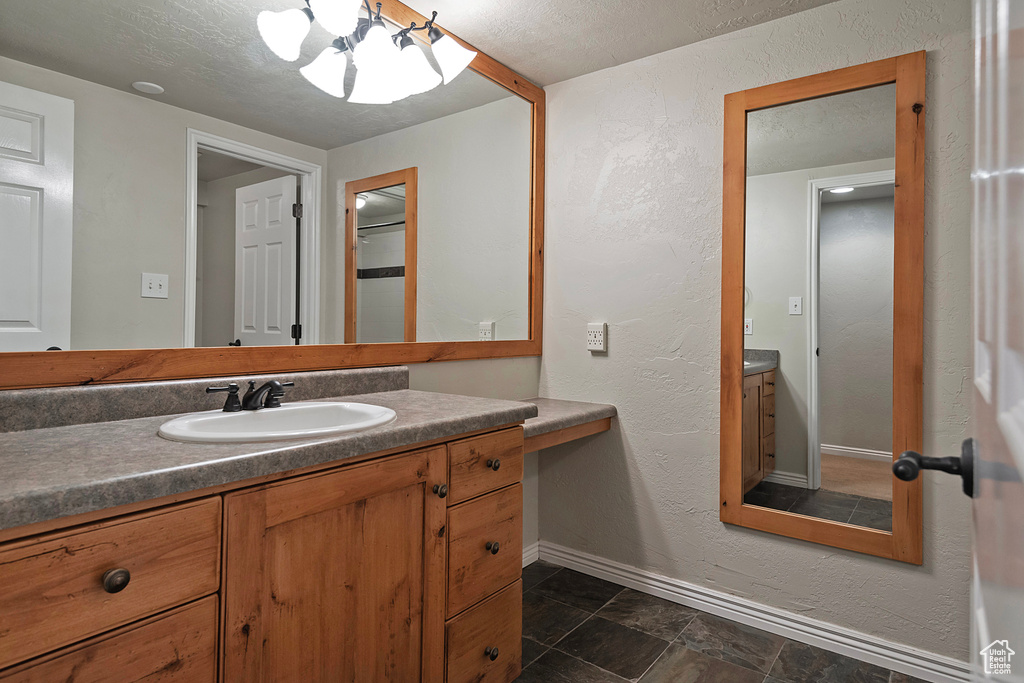 Bathroom featuring vanity and a textured ceiling