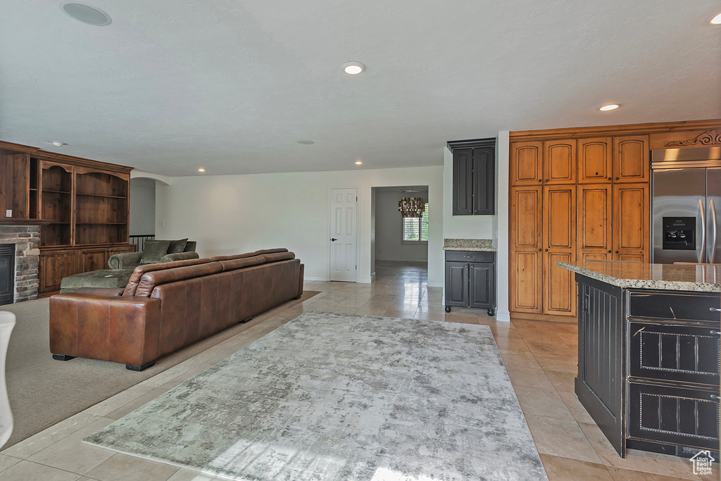 Tiled living room featuring a brick fireplace