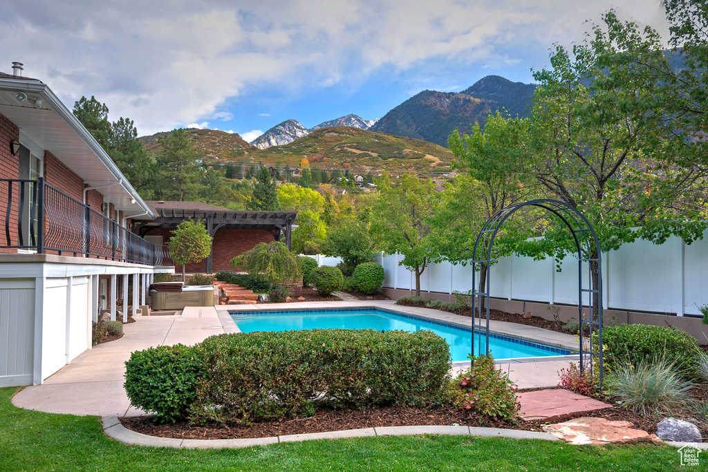 View of pool with a mountain view