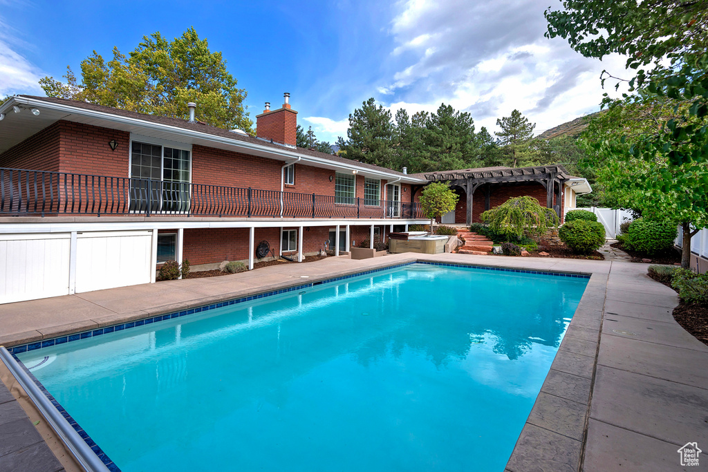 View of pool with a pergola