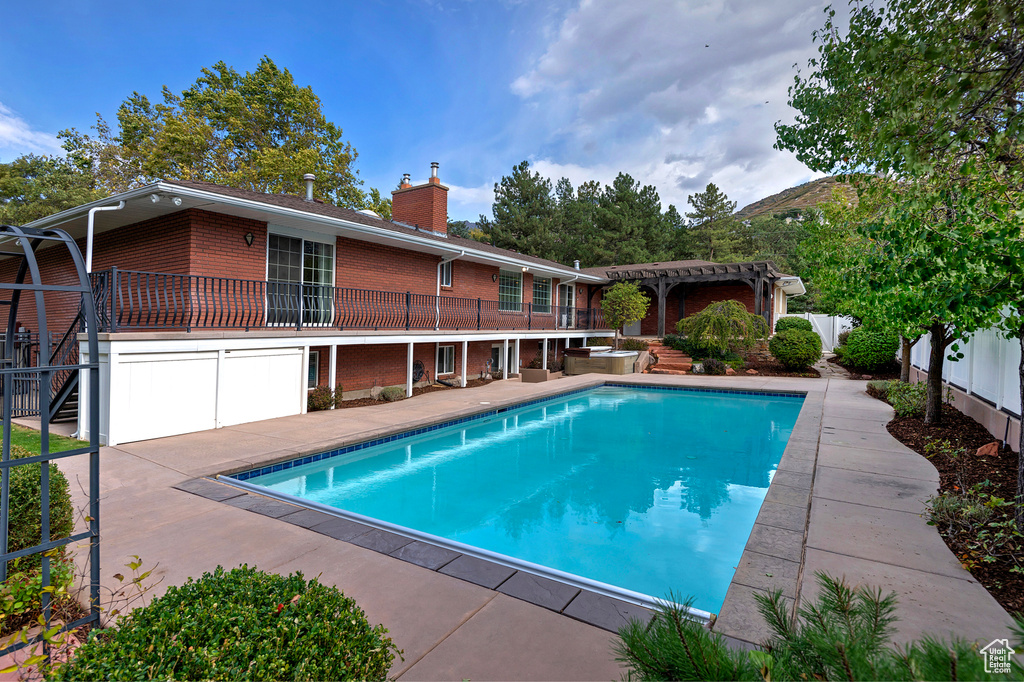 View of swimming pool with a pergola, a patio area, and a mountain view