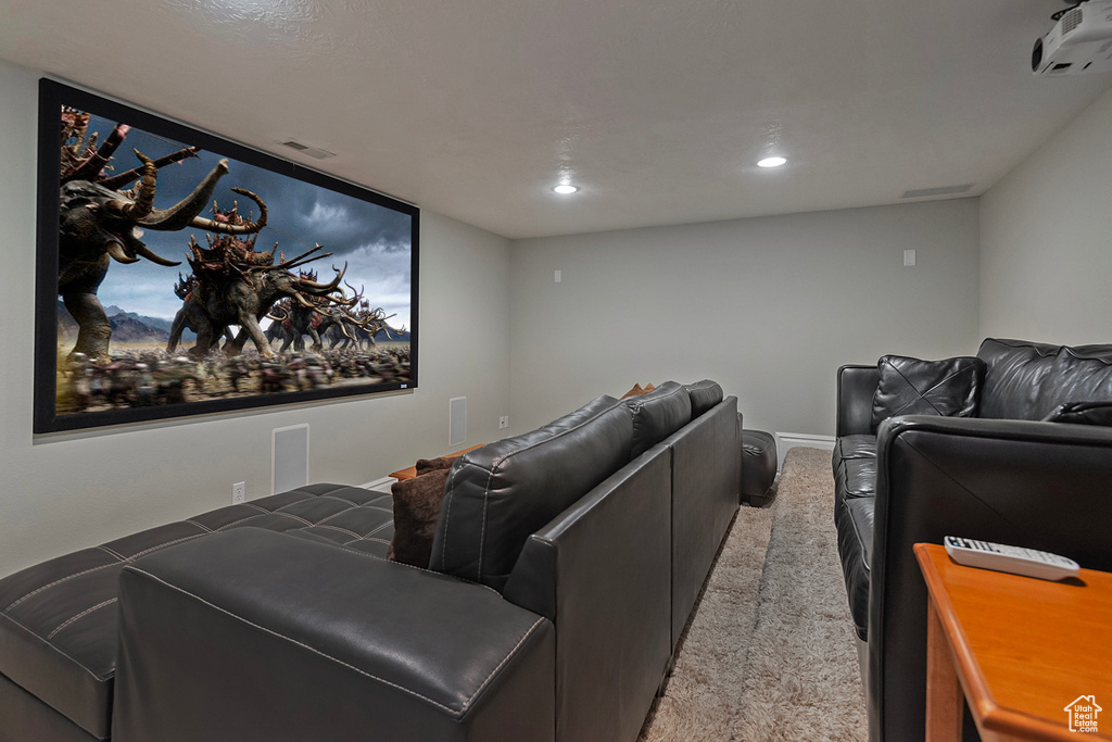 Home theater featuring light carpet