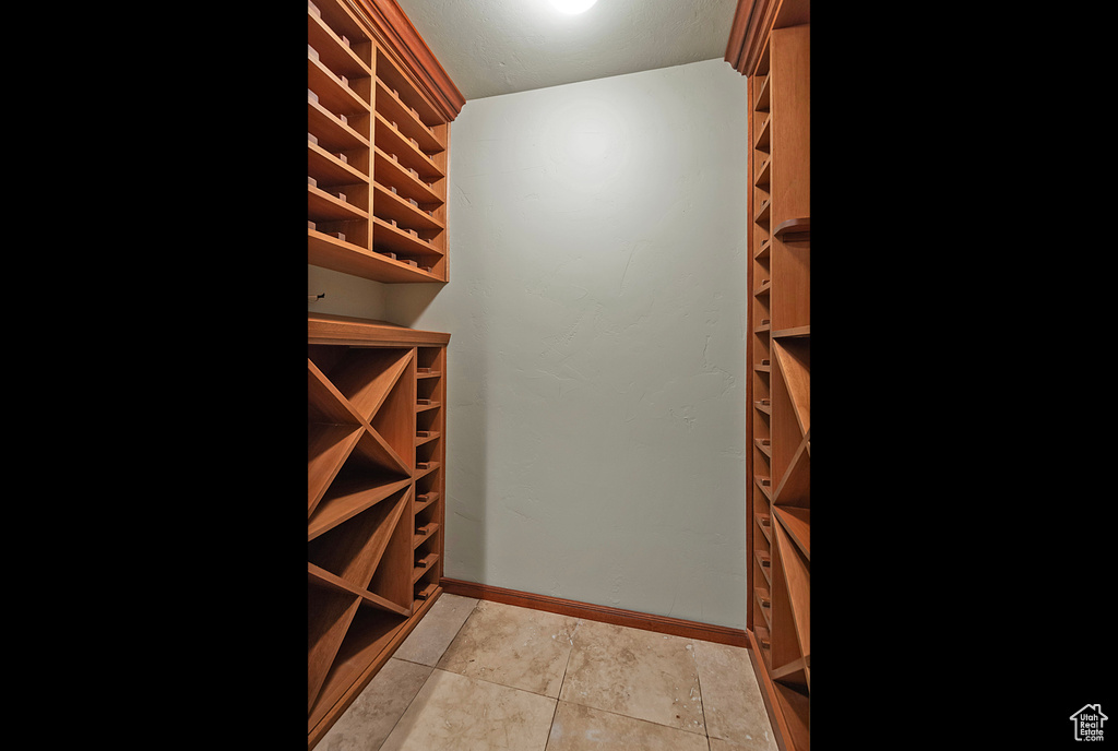 Wine cellar featuring light tile patterned flooring