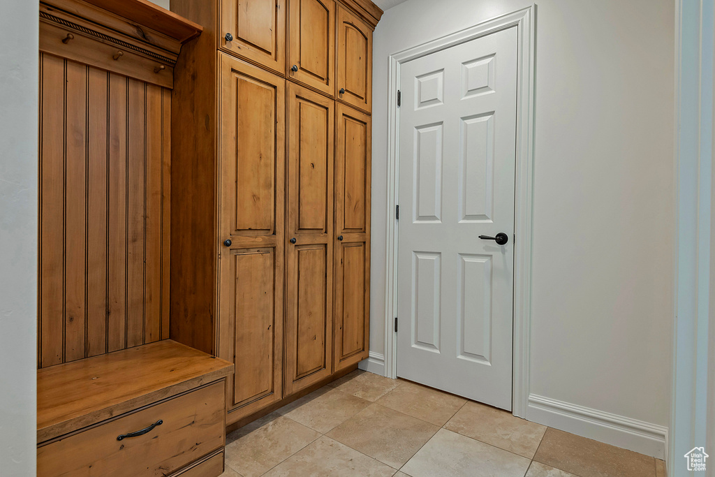 Mudroom with light tile patterned floors