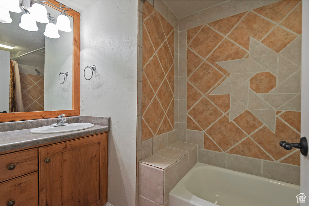 Bathroom featuring vanity and shower / tub combo with curtain