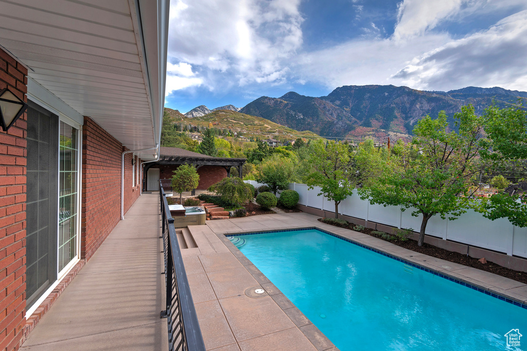 View of swimming pool featuring a patio and a mountain view