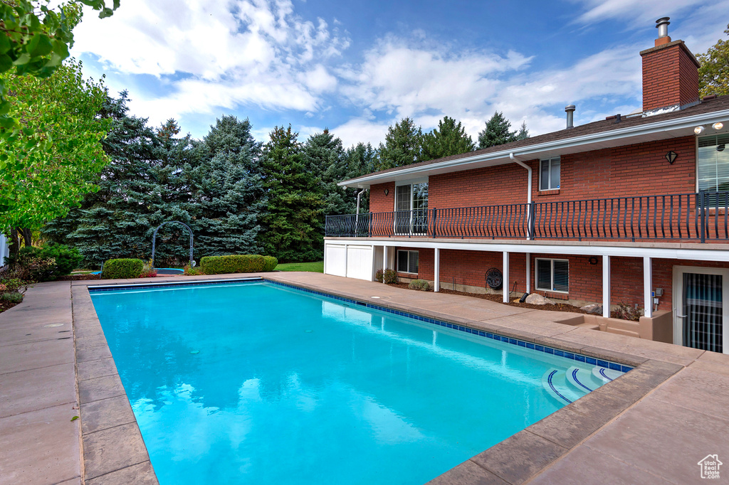 View of pool with sink and a patio