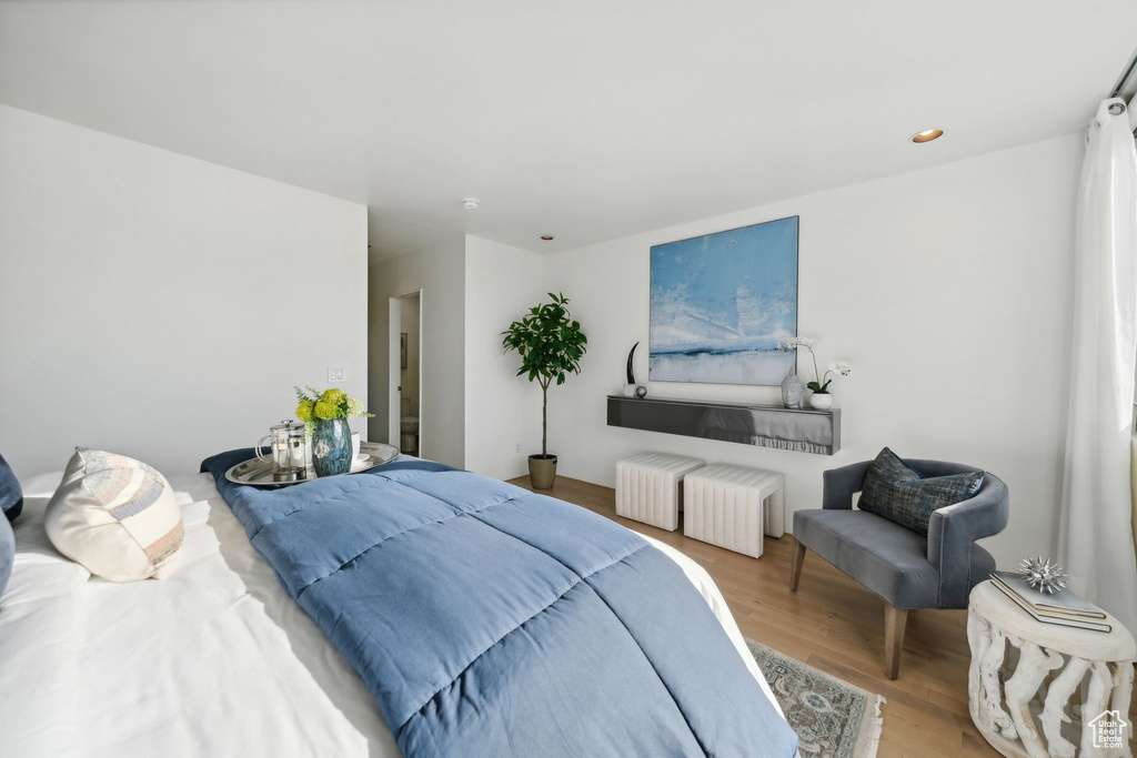 Bedroom featuring hardwood / wood-style flooring and radiator heating unit