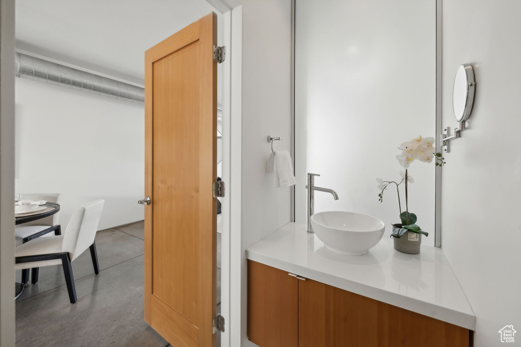 Bathroom with vanity and concrete floors