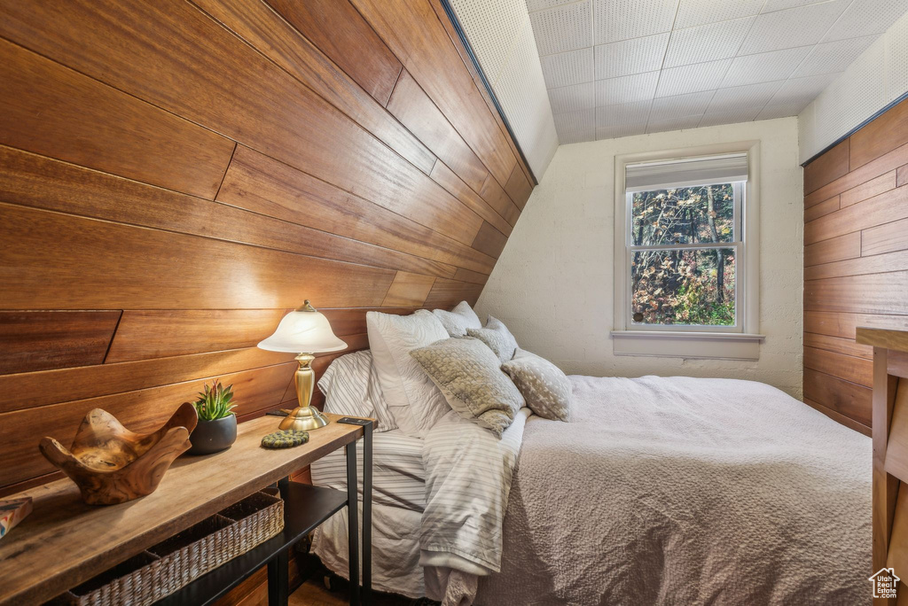 Bedroom with wood walls