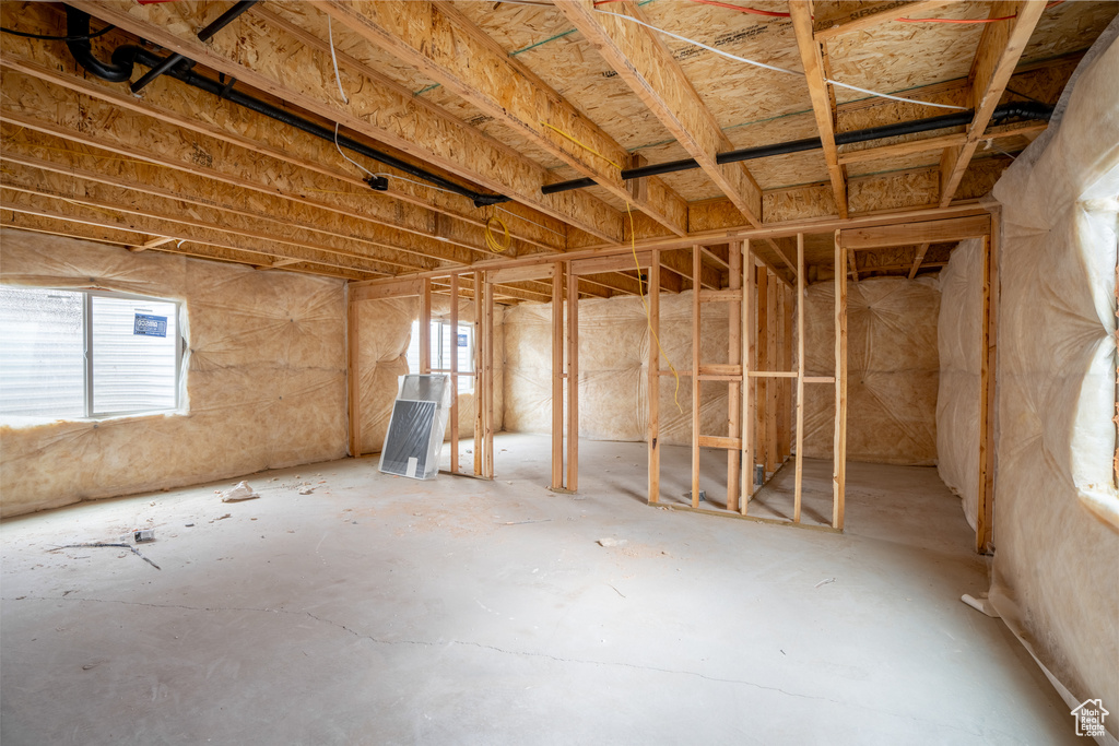 Misc room with a wealth of natural light and concrete flooring