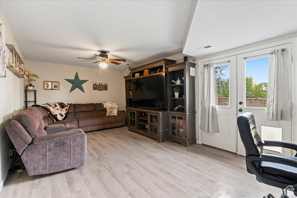 Living room featuring light wood-type flooring and ceiling fan