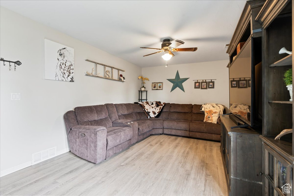 Living room featuring light hardwood / wood-style floors and ceiling fan