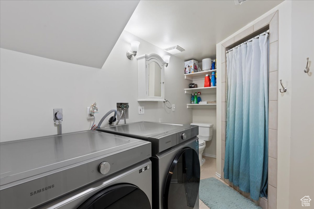 Laundry area with washing machine and clothes dryer