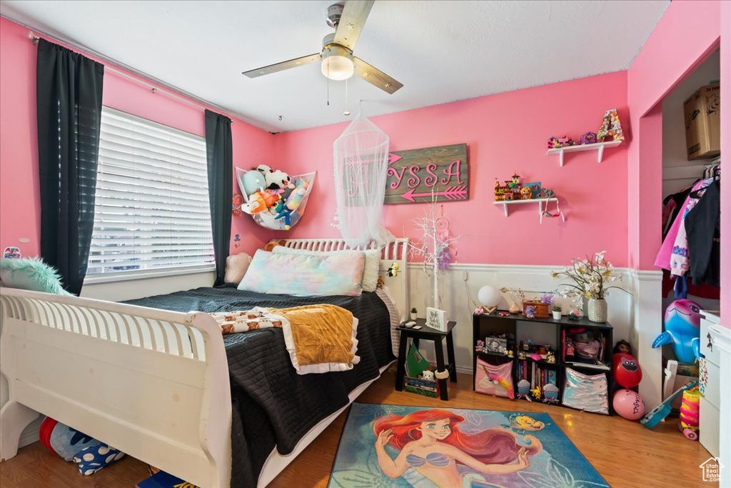 Bedroom with hardwood / wood-style flooring and ceiling fan