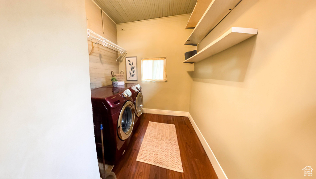 Laundry room featuring dark hardwood / wood-style floors and washer and clothes dryer