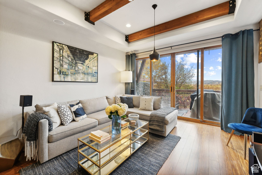 Living room featuring beam ceiling and hardwood / wood-style floors