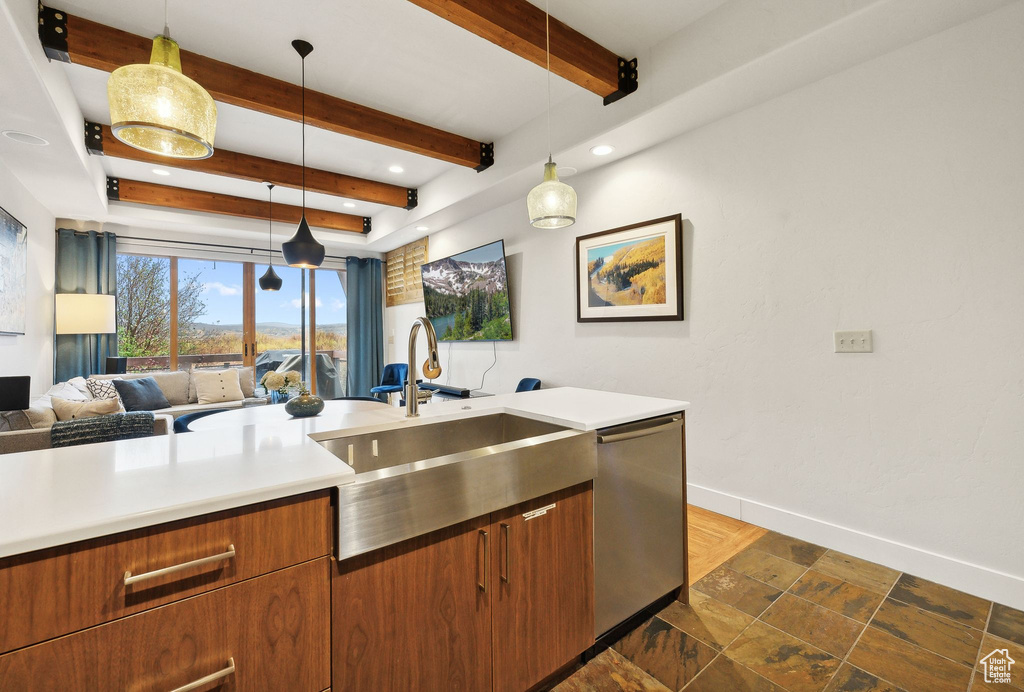 Kitchen with sink, beam ceiling, decorative light fixtures, and dishwasher