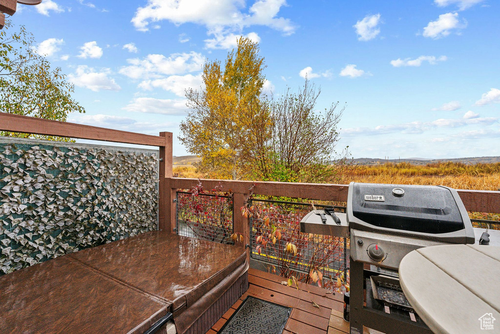 Wooden terrace featuring area for grilling