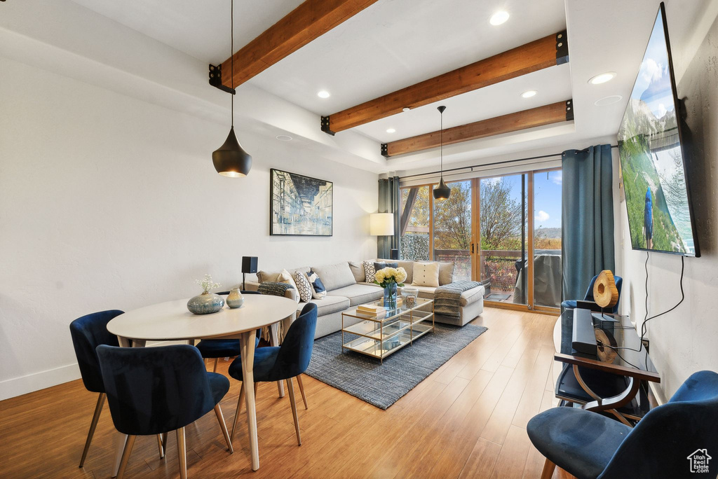 Living room with wood-type flooring and beamed ceiling