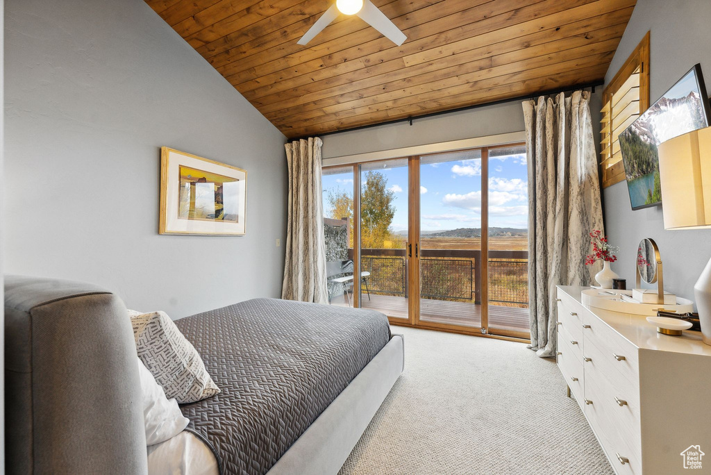 Bedroom featuring wood ceiling, access to exterior, ceiling fan, lofted ceiling, and light colored carpet