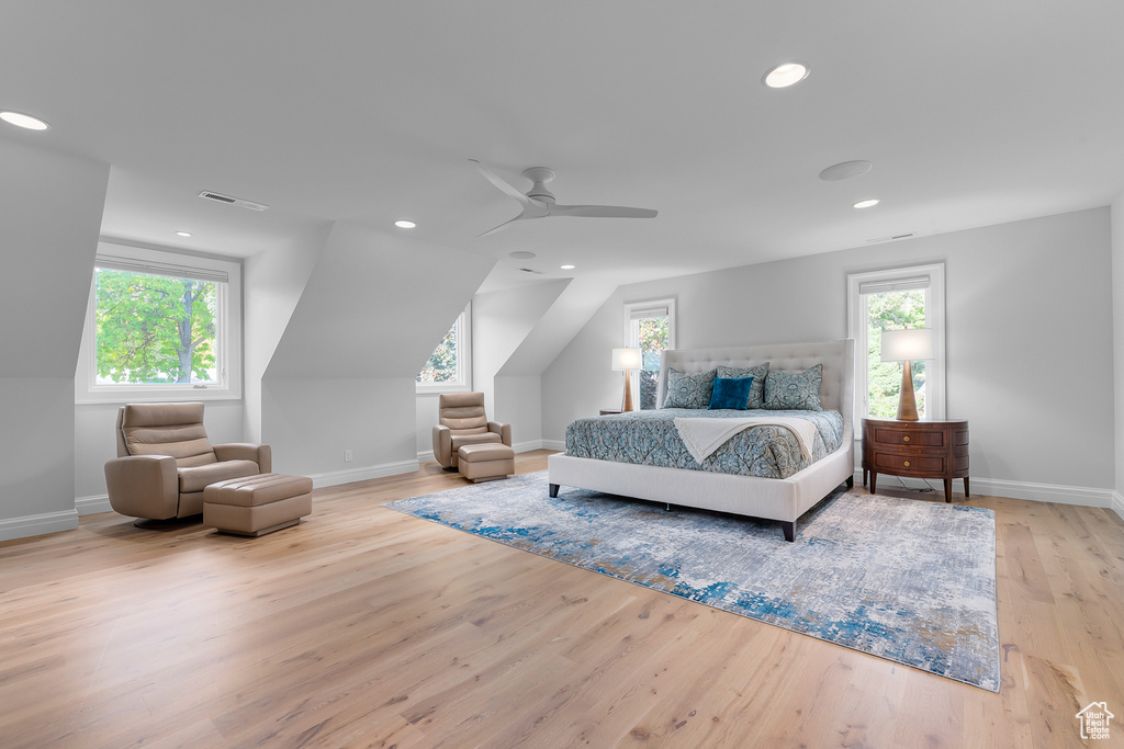 Bedroom featuring multiple windows, light hardwood / wood-style floors, and ceiling fan