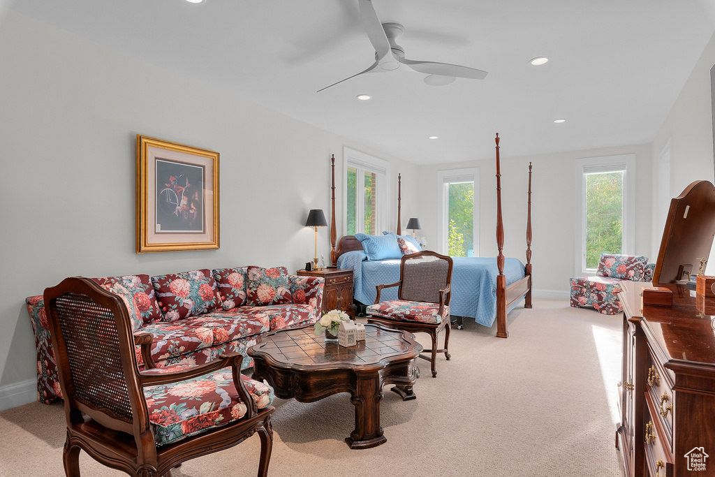 Carpeted living room with ceiling fan