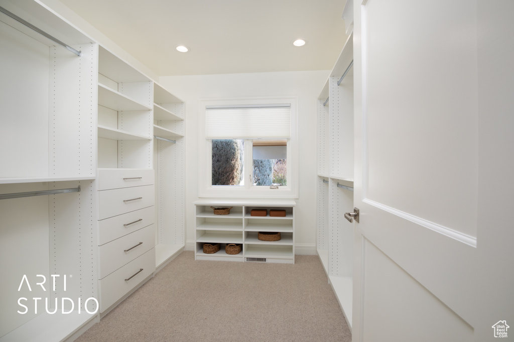 Spacious closet with light colored carpet