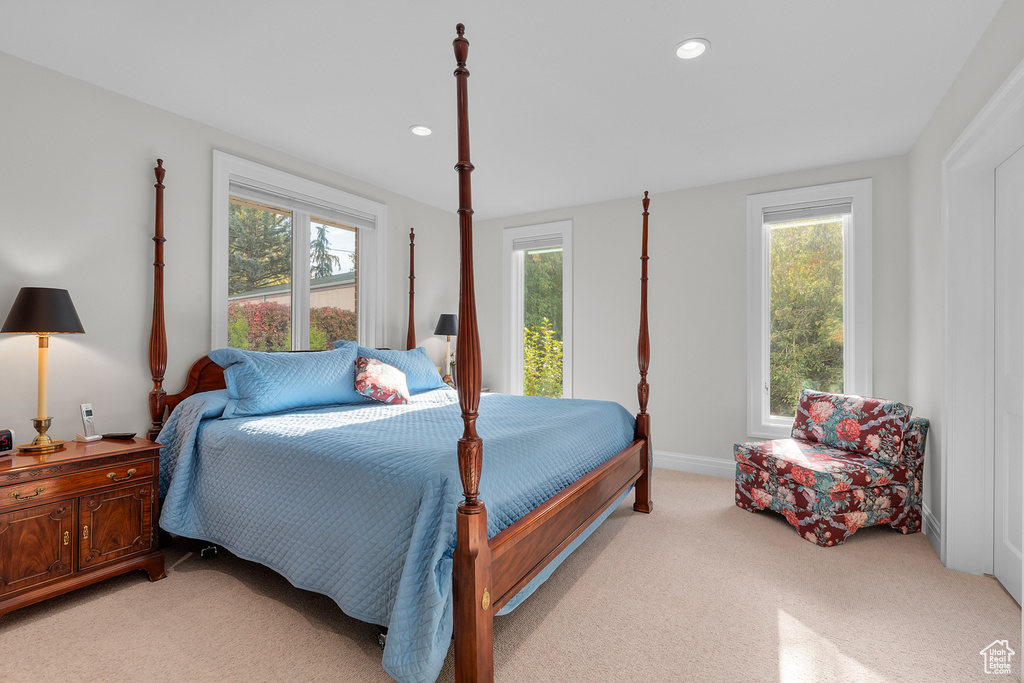 Bedroom featuring light carpet