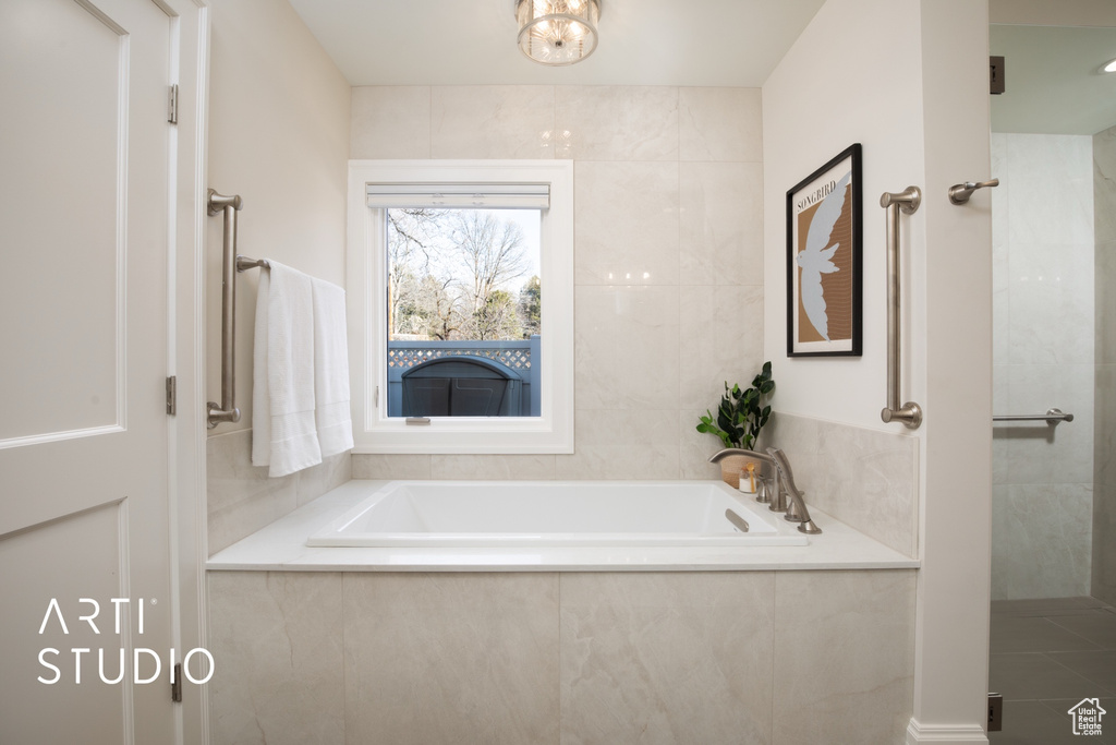 Bathroom featuring tiled bath