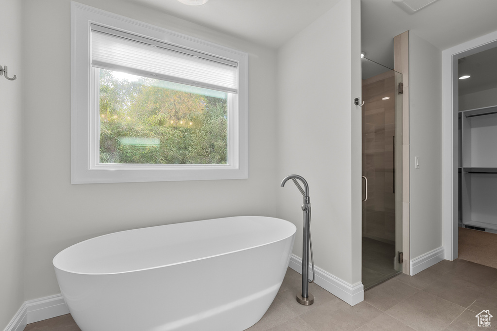 Bathroom with tile patterned floors and separate shower and tub