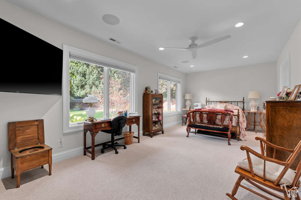 Bedroom featuring light colored carpet and ceiling fan