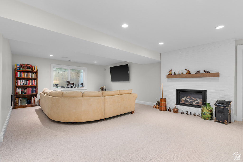 Living room featuring carpet floors and a large fireplace