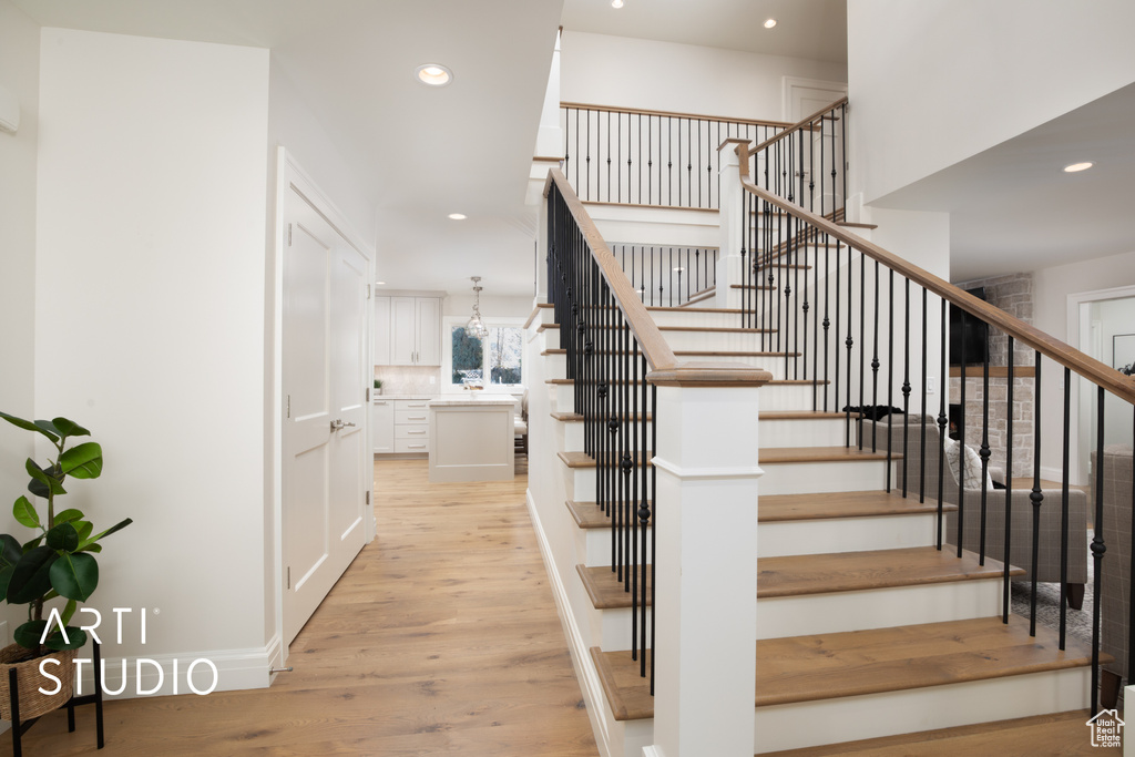 Staircase featuring hardwood / wood-style floors