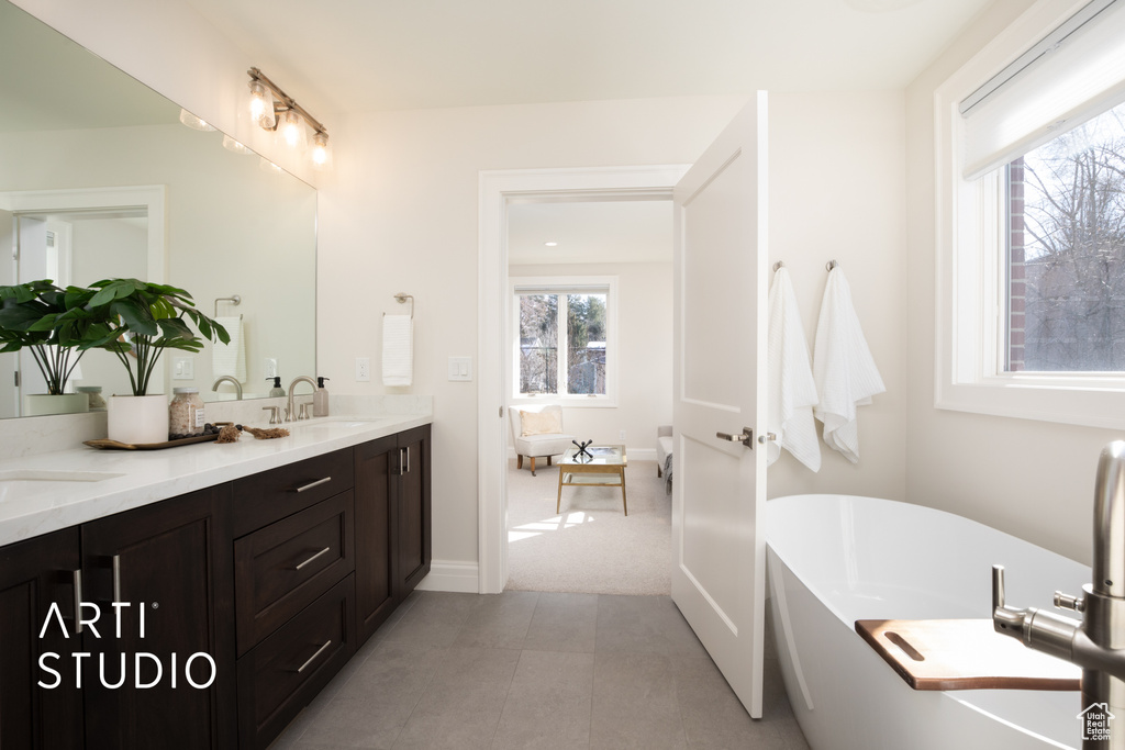 Bathroom with vanity and a bath