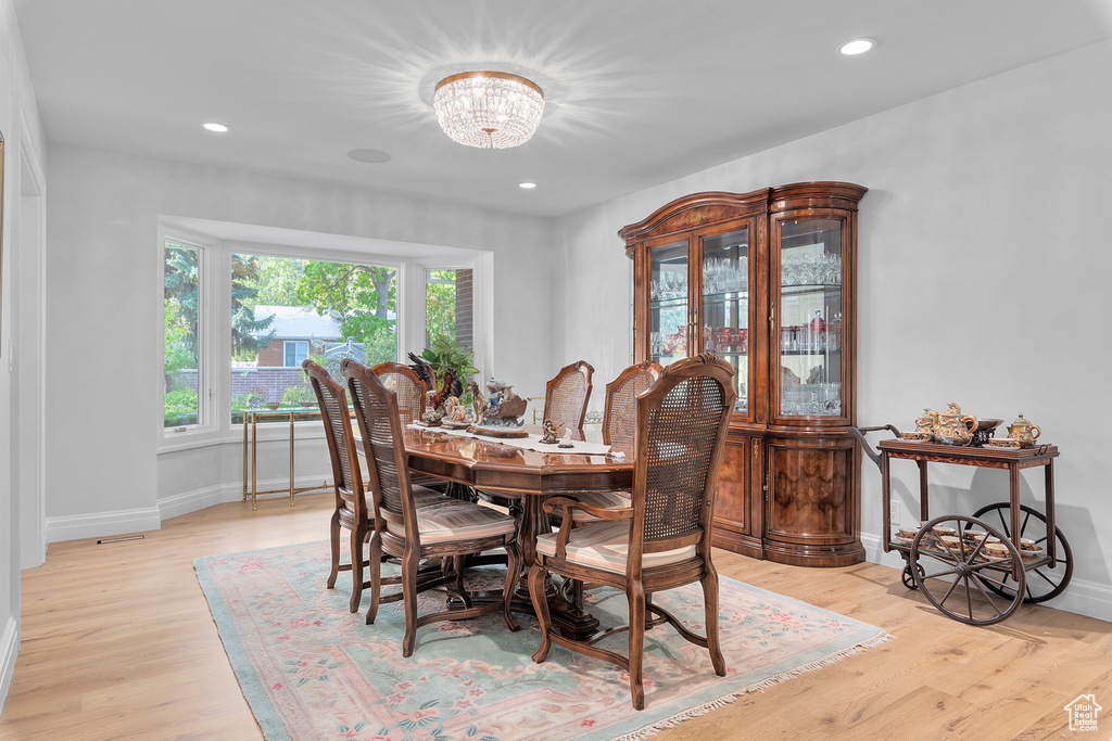 Dining area with an inviting chandelier and light wood-type flooring