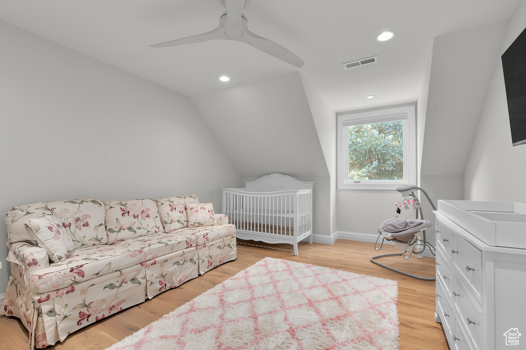 Bedroom featuring light hardwood / wood-style floors, vaulted ceiling, and ceiling fan