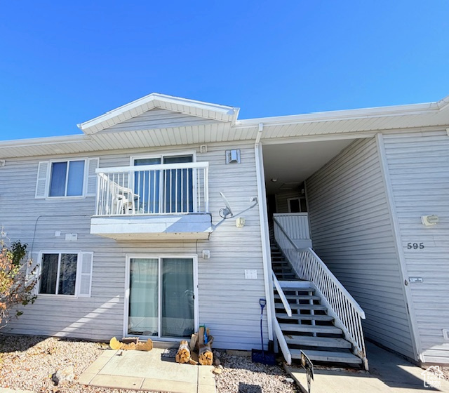 Back of house with a balcony