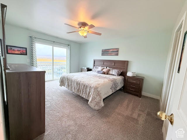 Carpeted bedroom featuring ceiling fan and access to exterior