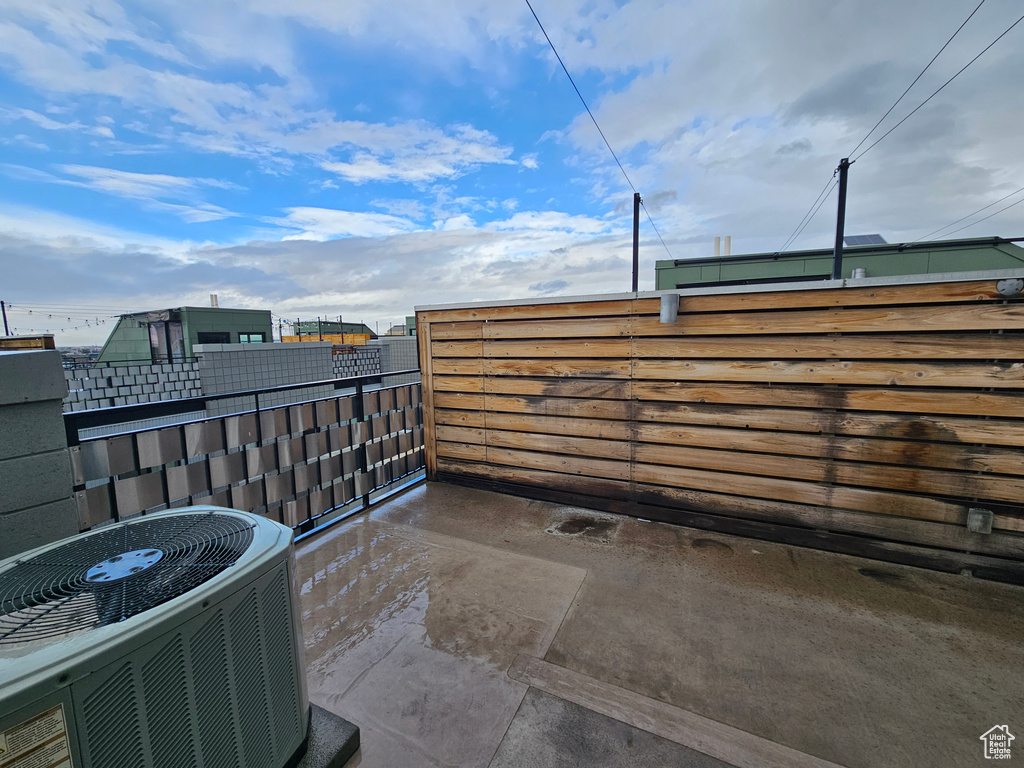 View of patio / terrace with cooling unit and a balcony